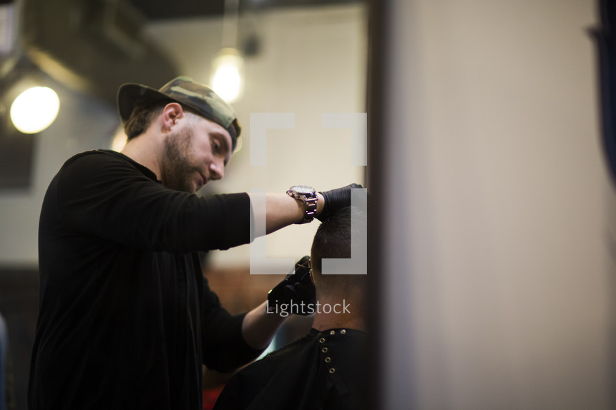 a man giving a haircut at a barber shop.