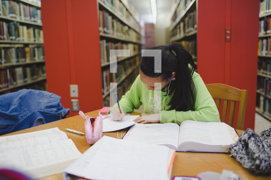 college girl studying in a library 