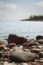 Rocks and pebbles in front of the sea