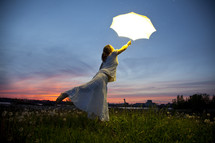 a woman holding an open umbrella and floating 