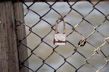 a love lock on a chain link fence 