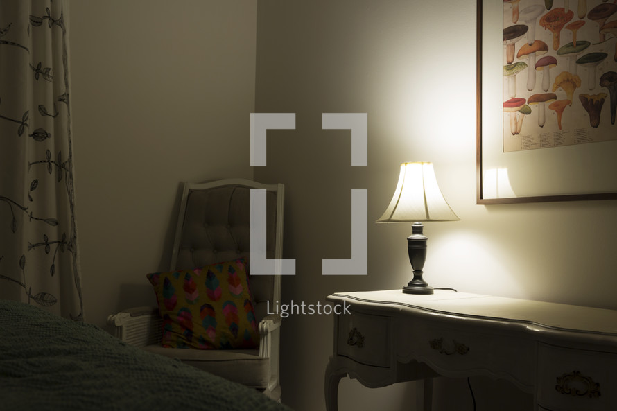 Soft light from a lamp illuminates a bedroom.