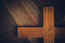 wooden cross on a wood floor 