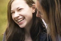 mother and teen daughter laughing together 