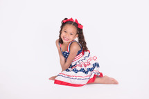 a portrait of a girl child in a patriotic dress 