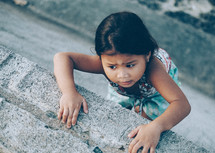 a girl climbing up a wall 