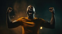 Portrait of black sportsman celebrating victory on dark background with smoke