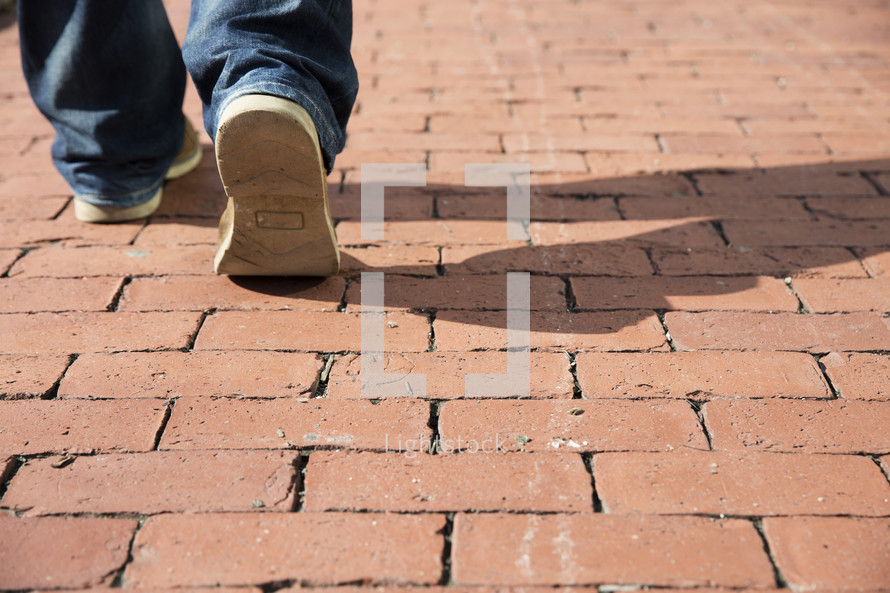 feet walking on a brick patio 