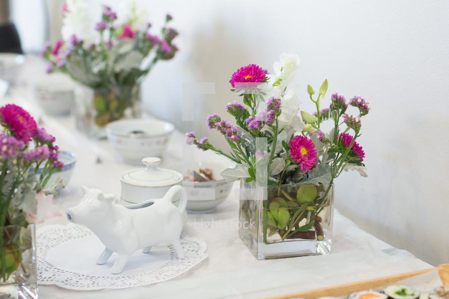 gravy boat and flowers on a set table 