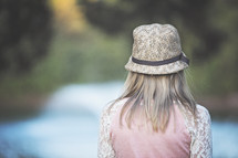 teen girl in a hat with back to the camera 