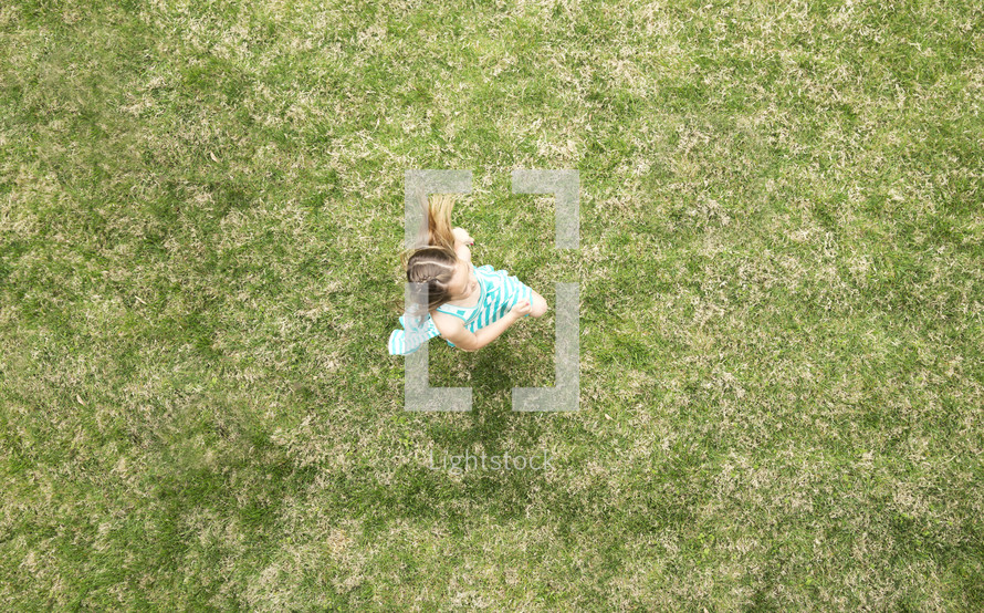 little girl running in grass.