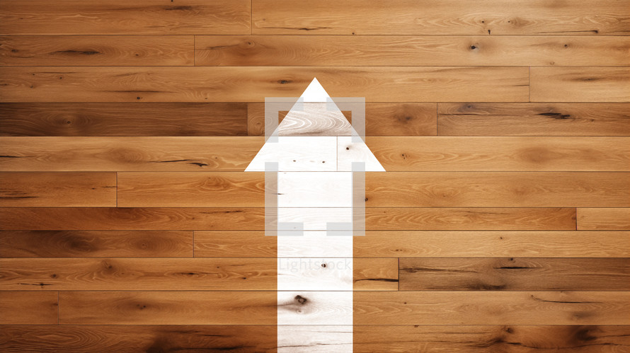 White arrow pointing up on a wood background. 