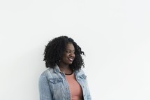 A portrait of an African American woman standing against a white background 