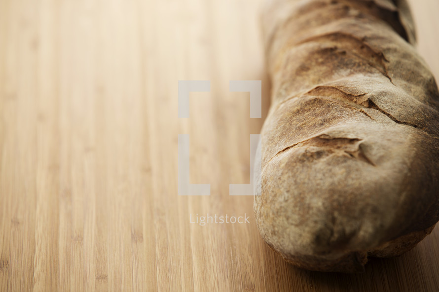 Loaf of fresh sourdough bread on a cutting board.