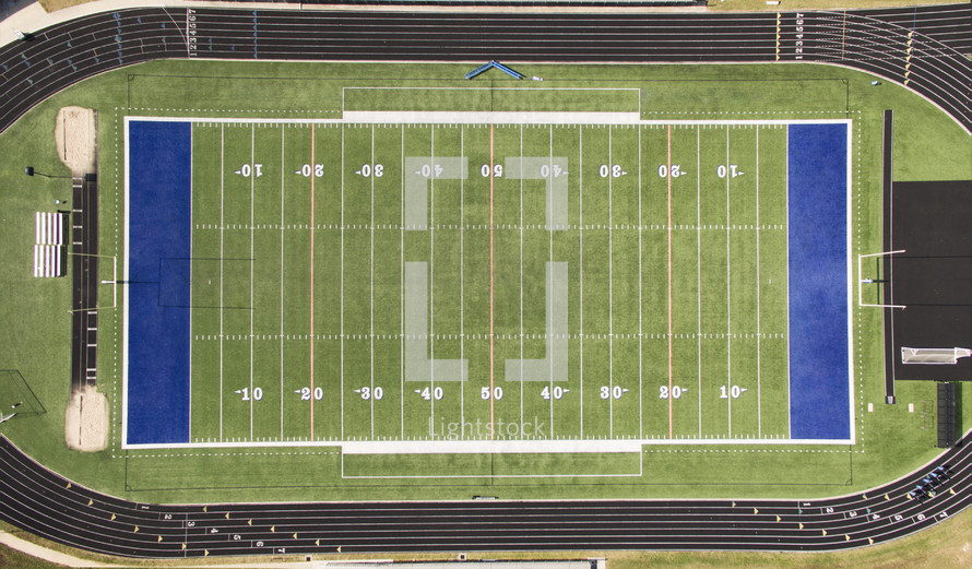 An aerial view of a football field surrounded by an athletic track.