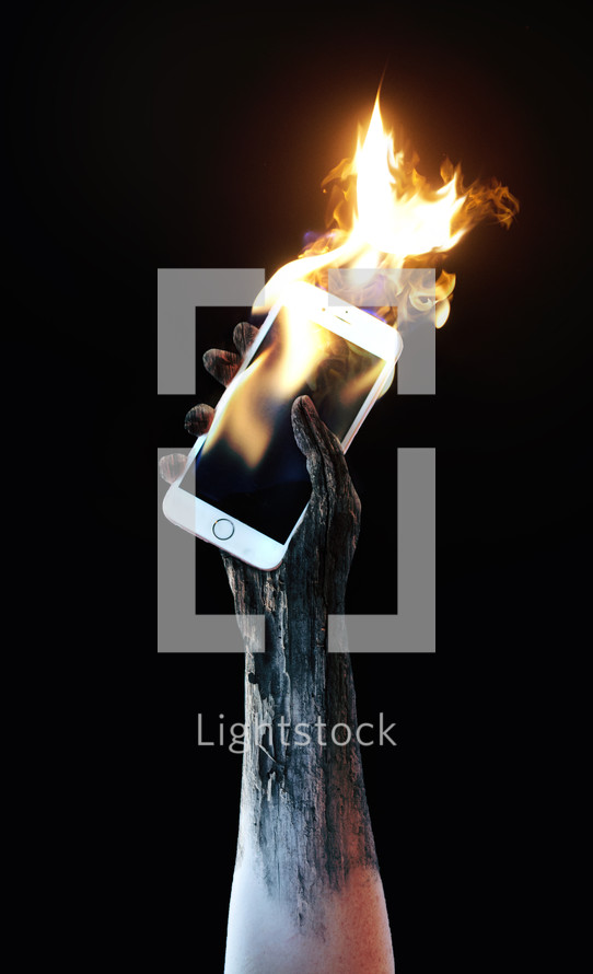 a raised tattooed arm holding a burning cellphone 