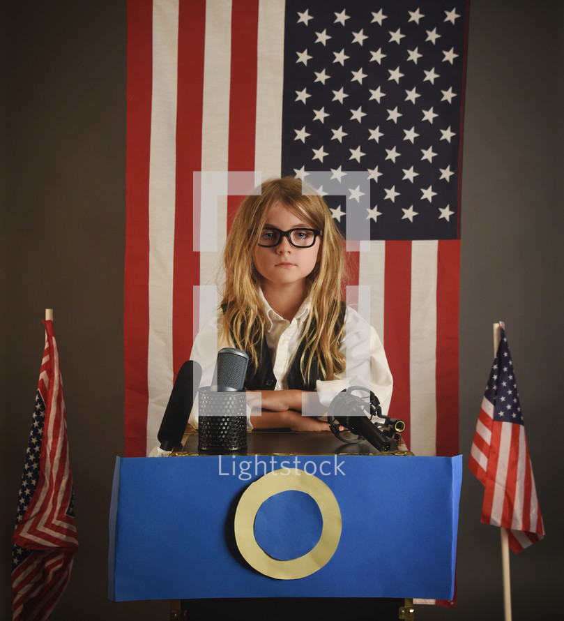 girl standing at a podium running for president 