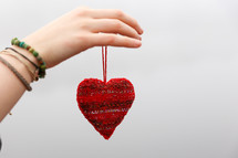 woman holding a heart ornament 