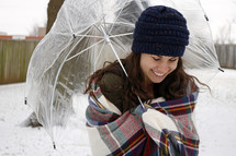 a woman holding an umbrella in snow 