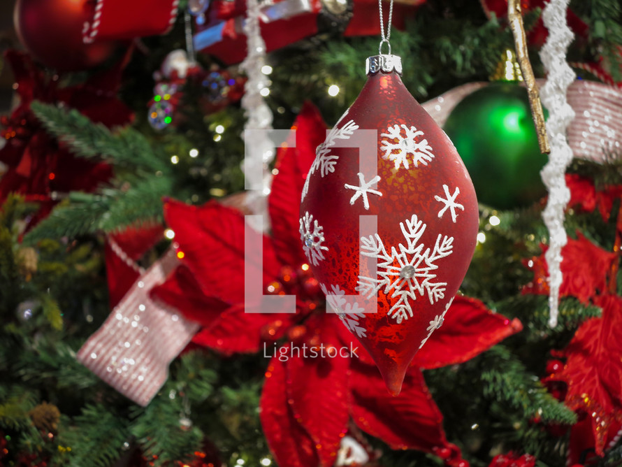 Red snowflake Christmas ornament decoration on the tree