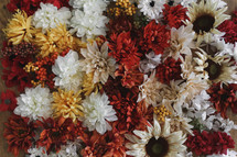 artificial fall flowers on a table