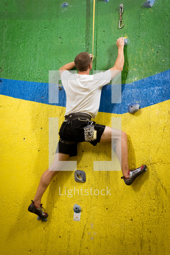 rock climbing on a climbing wall 