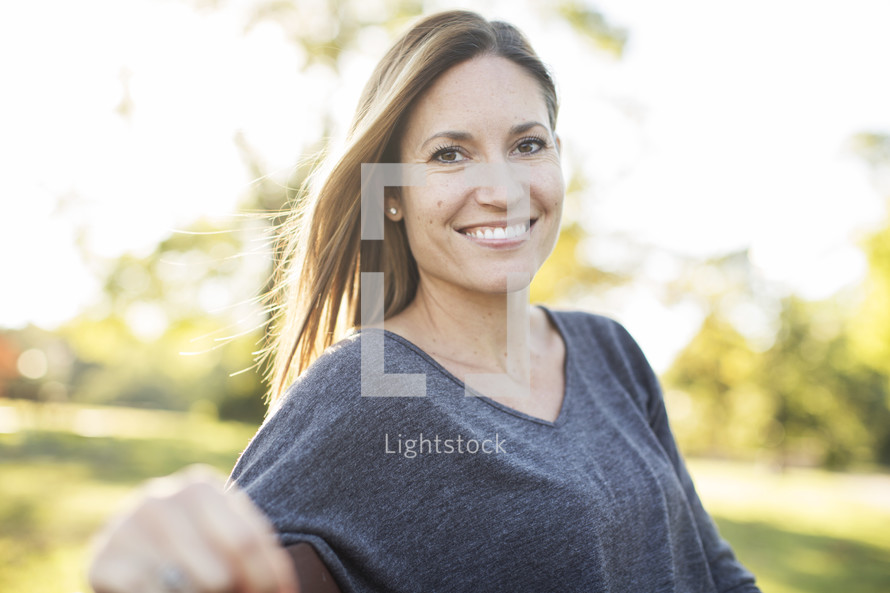 a picture of a smiling woman outdoors 