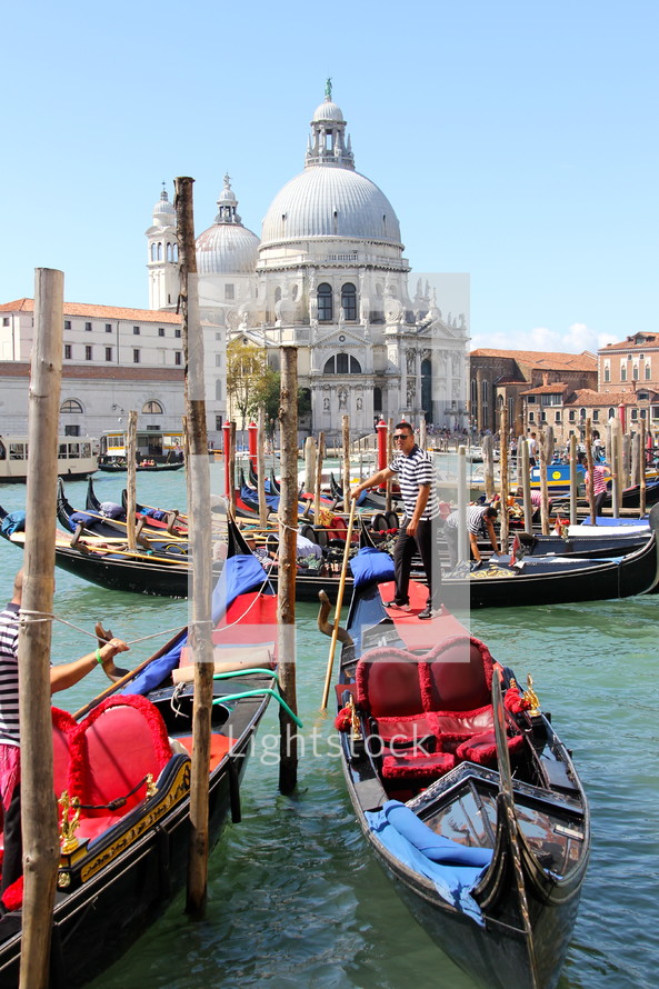 Gondolas await passengers in the Grand Canal. In the background the church of Santa Maria della Salute.