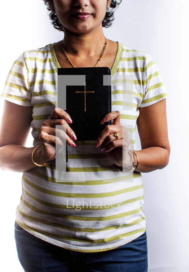 a woman holding out a Bible 