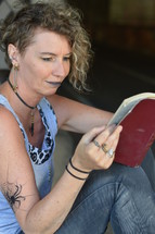a woman battling addiction reading a Bible 