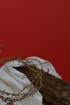 crown of thorns, a piece of cloth and a wooden beam 