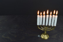 menorah with seven burning candles