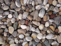 Many different colors and shapes of river rocks.