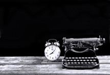 antique typewriter and alarm clock 