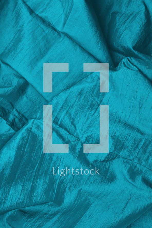 bright turquoise satin fabric as neutral background