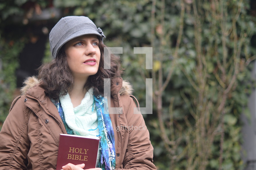 woman holding a bible and thinking about God and his word