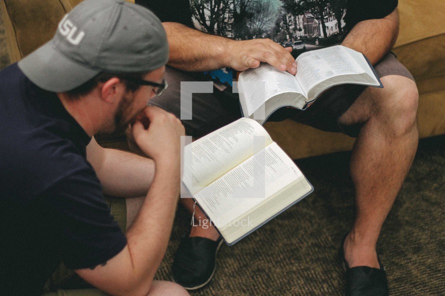 Two men sitting and studying the Bible together.
