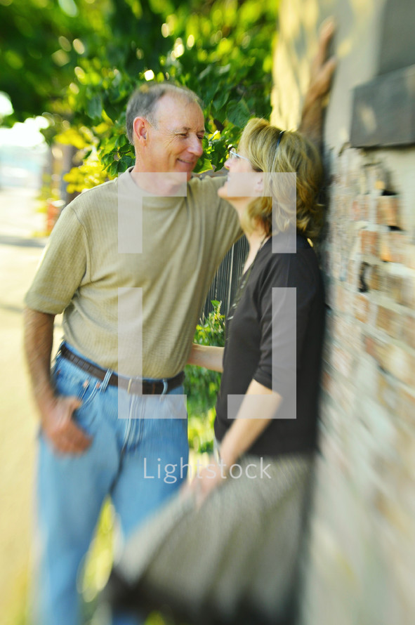 Smiling couple standing outdoors.
