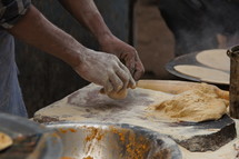 Man kneading dough in an indian bakery