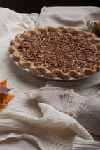 pecan pie on a beige tablecloth 