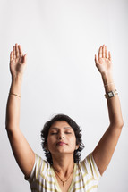a woman standing with raised hands 