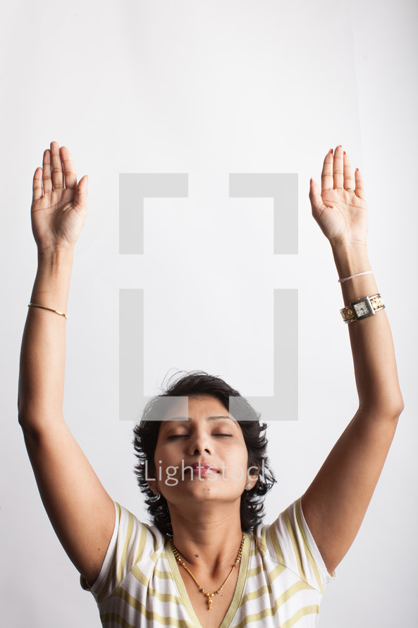 a woman standing with raised hands 