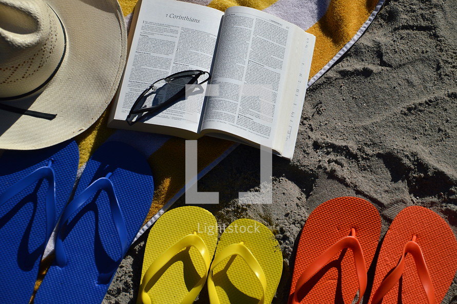 reading the bible at the beach in the family vacation. 
Bible, read, reading, study, studying, quiet time, quiet, time, family, summer, vacation, beach, sand, ocean, swimming pool, swim, swimming, free, free time, summertime, holiday, holidays, families, fun, sun, happy, colorfully, colorful, color, multicolored, blue, red, yellow, orange, flip flop, sandal, sandals, bathing shoe, bathing shoes, shoe, shoes, bathing, bath, thong, thongs, beach slide, beach slides, play, playing, relax, relaxing, chill, chilling, towel, glasses, sunglasses, sunhat, sun hat, sun bonnet, bonnet, sun shade, shade, sunshine, sun, shine, shining, size, different, various, father, mother, child, children, open, Corinthians