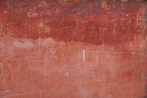 Ancient red brick an plaster wall with Chinese writing