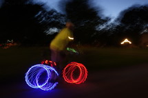 glowing lights of bicycle wheels at night 