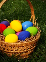 multicolored eggs in a basket
