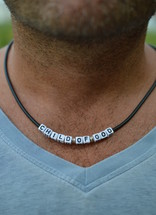 child of God necklace around a man's neck 