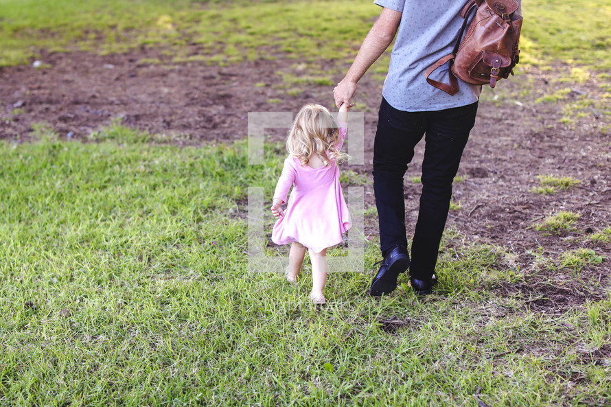 father and daughter walking holding hands 