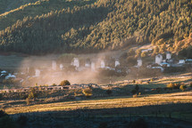Foggy mountain village at sunset