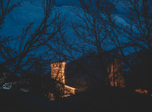 Lit stone tower on the winter night